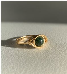 These Moss agate beads are absolutely gorgeous! Each one is completely unique and they make a great ring to wear every day.  -Handmade  -Available in multiple sizes  -Amazing gift idea Handmade Gold Agate Ring, Handmade 14k Gold Filled Rings, Adjustable Handmade 14k Gold Filled Ring, Wire Wrapped 14k Gold Filled Rings As Gift, Wire Wrapped 14k Gold Filled Rings Perfect For Gifts, 14k Gold Filled Wire Wrapped Rings As Gifts, Gold Wire Wrapped Spiritual Ring, Gold Wire Wrapped Healing Ring, Gold Moss Agate Round Jewelry