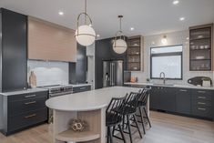 a large kitchen with an island in the middle and lots of counter space on one side