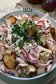 a bowl filled with meat and veggies on top of a table