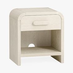 a white wooden night stand with an open drawer on one side and a round hole in the middle