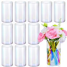 a vase filled with lots of pink and white flowers next to many empty glass cups