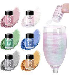 a hand is pouring glitter into a wine glass with the lid open and six different colors around it