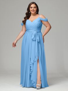 a woman in a blue dress posing for the camera