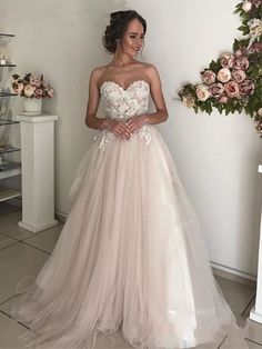 a woman in a wedding dress posing for the camera