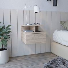 a bed room with a neatly made bed and a nightstand