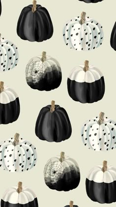 black and white pumpkins with polka dots are on a light gray wallpaper background