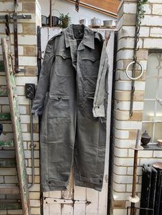 Vintage Bulgarian pilots flying suit overalls size XL. 100% Cotton. Collared, button through to crotch,  button down chest pockets, 2 lower pockets, button tabs at cuffs and legs - great utiliatarian workwear. Size:  Chest: 50 inches; Waist: 48 inches; Leg inseam: 28 inches; Total length: 61 inches. Weight: 2.6 kg (allow 5 kg volumetric weight once packed). Good vintage condition. For a larger selection of similar items, visit my website - www.AntheasAttic.co.uk (link on About page). Please cont Utility Overalls With Button Closure, Long Sleeve Overalls With Pockets For Outdoor, Military Style Long Sleeve Cotton Jumpsuit, Military Style Long Sleeve Cotton Jumpsuits And Rompers, Military Style Long Sleeve Khaki Jumpsuit, Khaki Military Style Long Sleeve Jumpsuits, Khaki Military Long Sleeve Jumpsuit, Utility Long Sleeve Jumpsuits And Rompers With Button Closure, Utility Jumpsuits And Rompers With Pockets For Outdoor