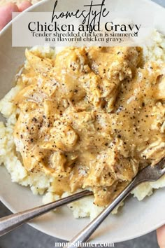 chicken and gravy on top of mashed potatoes in a white bowl