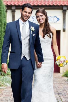 a man in a suit and tie standing next to a woman