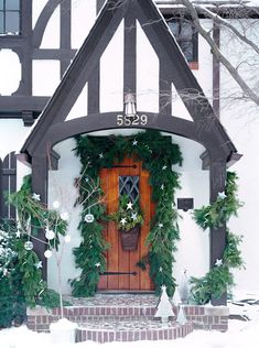 a house covered in snow and decorated for christmas