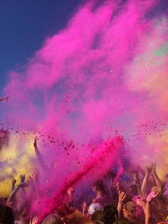 many people are throwing colored powder on each other