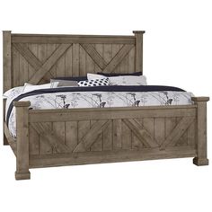 a bed with wooden headboard and foot board on top of it, in front of a white background