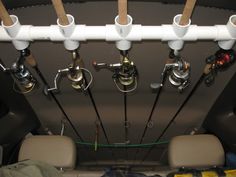 the inside of a vehicle with several different types of fishing rods hanging from it's ceiling