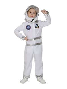 a little boy dressed in an astronaut suit and holding his hand up to the side