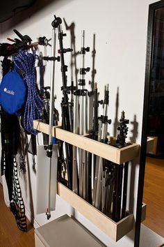 there is a rack full of skis and poles on the wall in this room