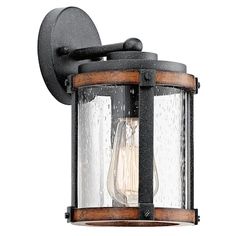 an outdoor wall light with a clear glass shade on the top and wood trim around the bottom