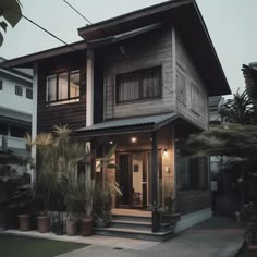 a house that has some plants in front of it