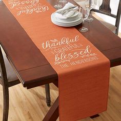 an orange table runner with the words, thank you and grateful written in white on it