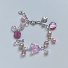 "A Handmade bracelet ✿ Made with freshwater pearls, rose quartz, mother of Pearl, glass crystal beads, metal accents, and glass beads ✿ Pearlescent peach, pink, sky blue, fuschia, lavender, and silver ✿ The bracelet has an additional 1-1.5\" of extension chain. Some beads may be added or removed depending on the length selected" Pink Charm Bracelet With Colorful Beads, Pink Charm Bracelet With Colorful Beads For Jewelry Making, Pink Pearl Beaded Bracelets For Jewelry Making, Silver Beaded Rose Quartz Bracelets, Pink Pearl Charm Bracelet, Feminine Pink Pearl Bracelets, Pink Beaded Bracelet With Pearl Charm As A Gift, Pink Beaded Bracelet With Pearl Charm For Gift, Pink Pearl Beaded Bracelets With Colorful Beads