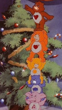 a group of teddy bears hanging from the top of a christmas tree with hearts on it