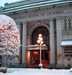 there is a building that has snow on the ground