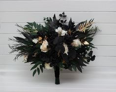 a bridal bouquet with white and black flowers