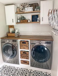 a washer and dryer in a laundry room with shelves on the wall above them