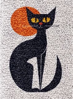 a black cat with an orange circle on it's head sits in front of a white background