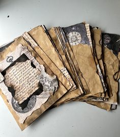 several pieces of old paper are stacked on top of each other, with torn edges