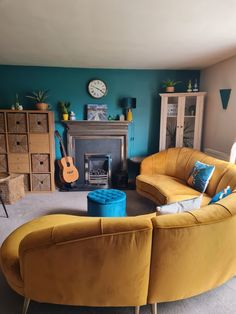 a living room with two couches and a guitar on the table in front of it