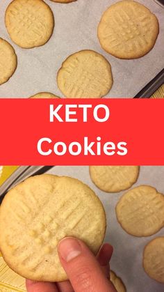 a person holding a cookie in front of some cookies on a baking sheet with the words keto cookies above it