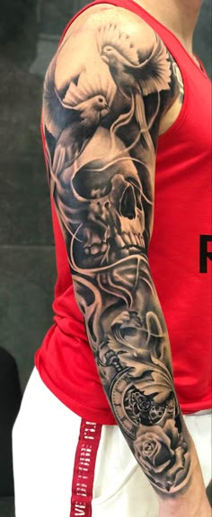 a man with a full sleeve tattoo on his arm