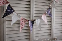 an american flag bunting hanging on the side of a house