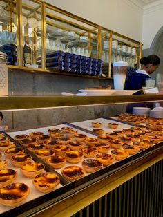 there are many pastries on the counter at this restaurant that is ready to be eaten