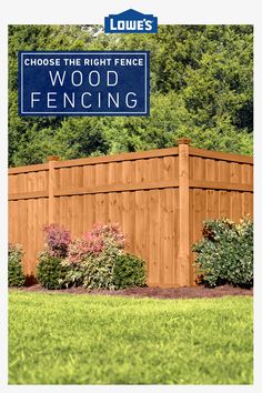 a wooden fence in front of some bushes and trees with a blue sign that says choose the right fence wood fencing