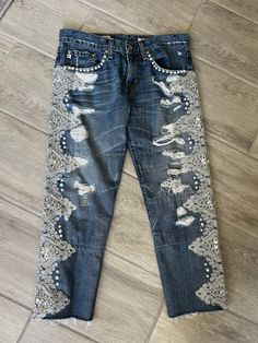 an old pair of jeans with embroidered details