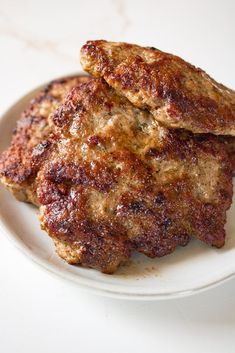 two meat patties on a white plate