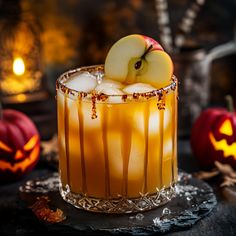 an apple sitting on top of a drink in a glass with ice and caramel garnish