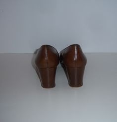 "Vintage Salvatore Ferragamo brown and white FF logo leather classic high heel loafer style pumps. Good pre-owned condition. No rips, tears, scratches, etc. Women's size 7 AA. Made in Italy. Heel height-2\". Classic look!" Brown Slip-on Court Shoes For Business, Brown Slip-on Heels With Round Toe, Brown High Heel Leather Loafers, Brown Rubber Sole Court Shoes For Business, Brown Business Court Shoes With Rubber Sole, Brown Round Toe Court Shoes For Office, Business Brown Court Shoes With Rubber Sole, Office Slip-on Brown Heels, Brown Slip-on Heels For Office