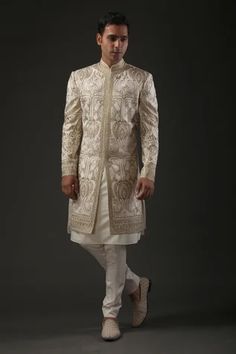 Ivory matka silk sherwani with zari and hand embroidery in floral motifs and silk lined.
Component: 1
Pattern: Embroidered
Type Of Work: Zari
Neckline: Mandarin
Sleeve Type: Full
Fabric: Matka Silk, Lining: Silk 
Color: Ivory
Other Details: 
Zari work
Note: Pant and inner kurta worn by the model is not for sale
Occasion: Groom,Wedding - Aza Fashions Cream Sherwani, Seema Gujral, Sherwani For Men Wedding, Modern Indian Wedding, Sherwani Groom, Kurta Cotton, Mens Sherwani, Sherwani For Men, Wedding Sherwani