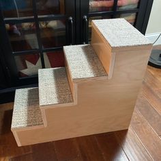 a set of stairs made out of plywood with carpet on the bottom and sides