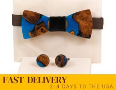 We are glad to present unique gift box for men - original bow tie and cufflinks of black resin and wood. Dimensions of bowtie: Width: 108 mm / 4.25in Length: 43 mm / 1.69in Diameter of cufflinks: 20 mm / 0.78in > High quality materials: - The finest timber of wild olive -- strong, stable and having beautiful color and grain is carefully selected by us. The epoxy-filled area has a natural edge, without disrupting the natural grain of the wood. - The item is finished with a durable varnish, which Dapper Blue Tie For Gift, Dapper Blue Tie Suitable For Gift, Dapper Blue Tie As Gift, Cufflinks For Father's Day Gift, Blue Bow Tie As A Gift, Elegant Suit And Tie Accessories Gift Box, Elegant Adjustable Suit And Tie Accessories For Gifts, Father's Day Jewelry Gift With Ties, Adjustable Suit And Tie Accessories For Father's Day Gift