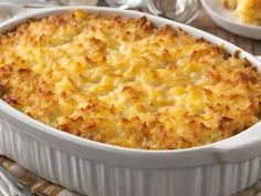 a casserole dish with cheese and bread crumbs on the side, ready to be eaten