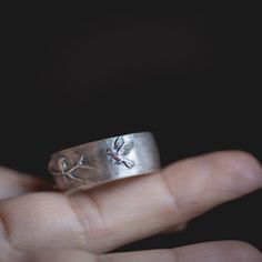 "I hand carved the birds and branch on this wedding band in jewellers wax, and had it cast, and a mold made of it. The photo with a blue ring shows the wax when I was working on the design. The \"lost wax\" casting method used means that the wax is all burned away, and the ring is solid 14k gold all the way through. This listing is for one ring in this design, customized in your ring size, cast in your choice of 14k gold; palladium white gold, rose gold or yellow gold. It will be plated in black Hand Cast Engraved Round Ring For Anniversary, Hand Cast Sterling Silver Engraved Ring For Wedding, Artisan Hand Forged Wedding Rings, Unique Hand Forged Engraved Wedding Ring, Unique Carved Rings For Wedding, Vintage Hand Forged Engraved Ring For Wedding, Hand Cast Engraved Ring For Anniversary, Artisan Engraved Sterling Silver Wedding Ring, Artisan Engraved Ring For Wedding