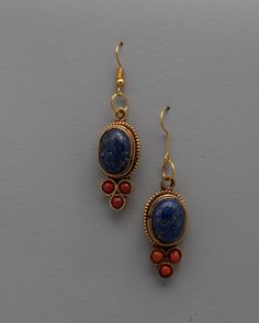 Dangle Gemstone Earrings About our product: The Dangle Gemstone Earrings, handcrafted on a copper and brass body with electro-gold plating, are a breathtaking example of beauty and craftsmanship combined. The exquisite inlay of semi-precious stones, such as coral and lapis lazuli, accentuates the beauty and allure of these earrings. Any ensemble is given a sophisticated and colorful pop when the coral stones' vivid red contrasts with the lapis lazuli's rich blue. These Dangle Gemstone Earrings a Fusion Style Brass Drop Earrings, Fusion Style Brass Earrings With Gemstones, Bronze Brass Jewelry With Natural Stones, Bronze Natural Stones Brass Jewelry, Bronze Brass Jewelry With Latkans, Bronze Dangle Earrings With Natural Stones, Handmade Gold Earrings With Lapis Lazuli, Artisan Earrings With Natural Stones And Brass, Copper Dangle Earrings With Natural Stones