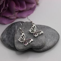 Antique silver cut out butterfly earrings with 925 Sterling silver hooks. These earrings would be a fabulous addition to anyone's earring collection. They are very understated elegant and truly stunning, a perfect gift for anyone who loves butterflies.  Matching butterfly pendant necklace available from our shop.  Made with   ⭐Antique silver butterfly charm (measures 25x13mm) ⭐925 Sterling silver ear hooks Finished with rubber bell shaped stoppers presented on a beautiful floral and birds card A Silver Earrings With Butterfly Charm, Nickel-free Silver Butterfly Earrings, Nickel-free Butterfly Shaped Silver Earrings, Silver Butterfly Charm Earrings, Silver Butterfly Charm Drop Earrings, Sterling Silver Butterfly Charm Earrings, Silver Butterfly Charm Earrings For Gifts, Silver Sterling Butterfly Earrings, Butterfly Shaped Sterling Silver Earrings