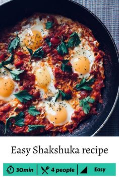 two eggs are in a skillet with herbs on top and the words easy shakshuka recipe below it