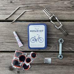 the repair kit is laid out on top of a wooden table next to some tools