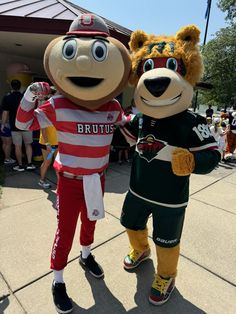 two people in mascot outfits standing next to each other