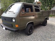 a brown van parked on top of a gravel road